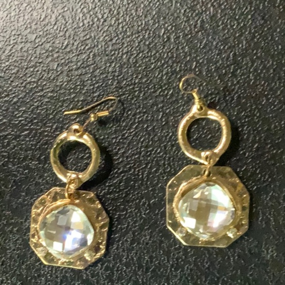 Silver tone earrings with clear faceted center
